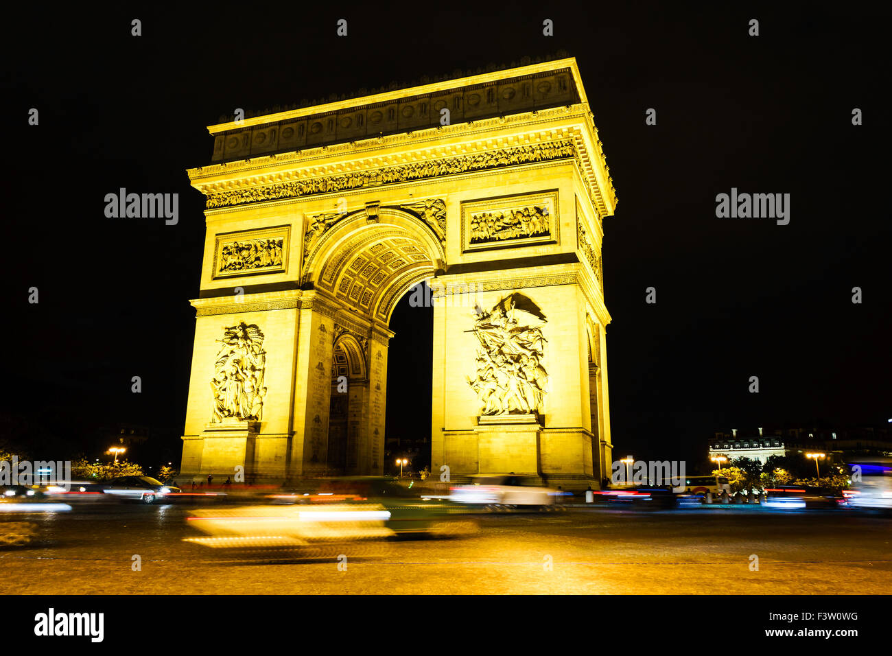 Cars zoom past the Arc de Triomphe on a summer's night. Paris, France. August, 2015. Stock Photo