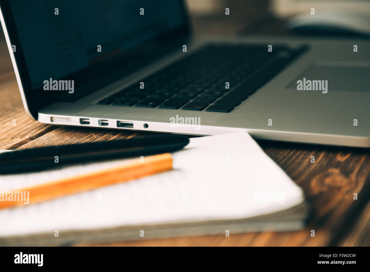 Workplace with open laptop on modern wooden desk Stock Photo - Alamy