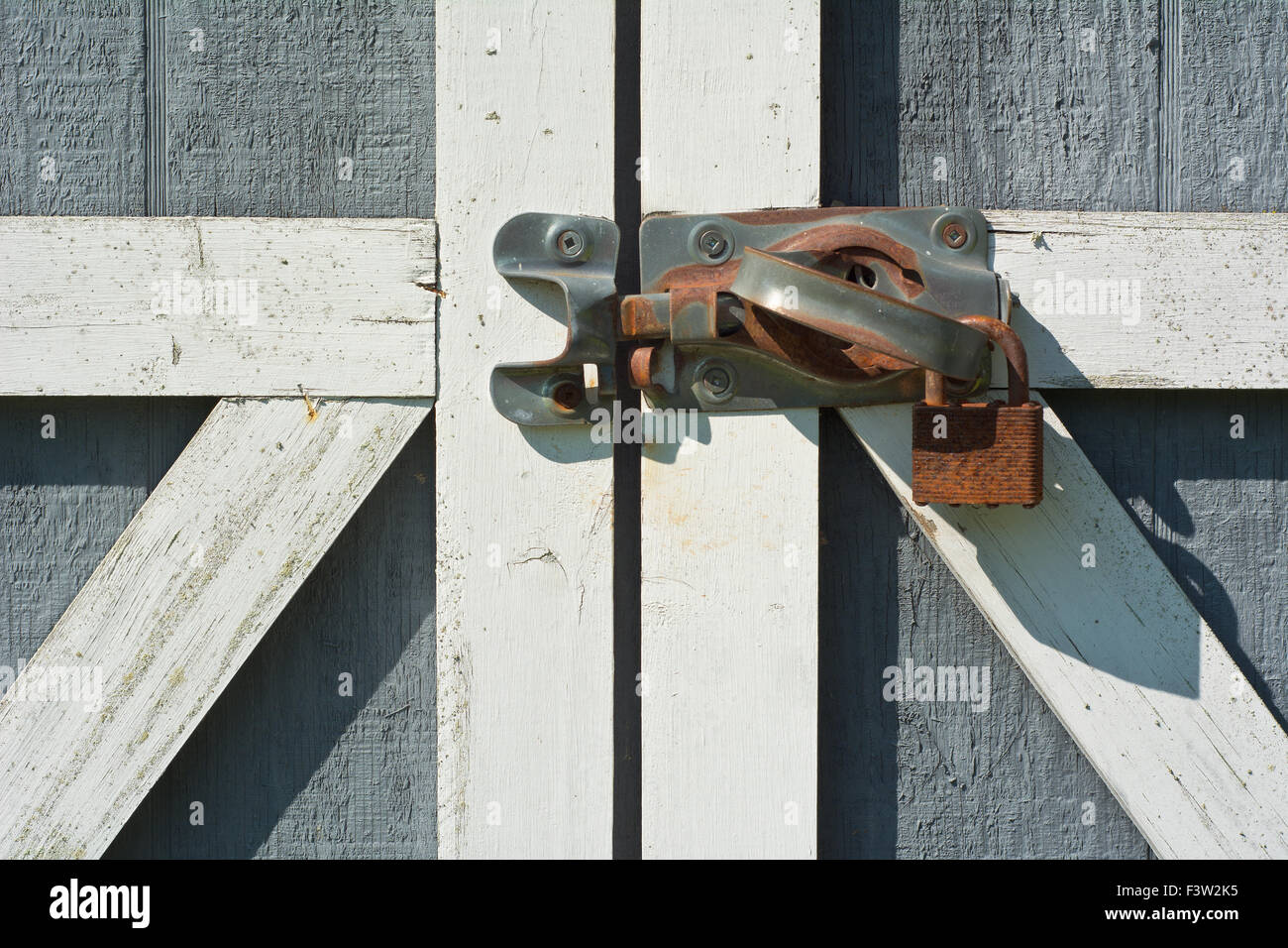 Tool Shed Door with Rusty Lock and Handle Stock Photo