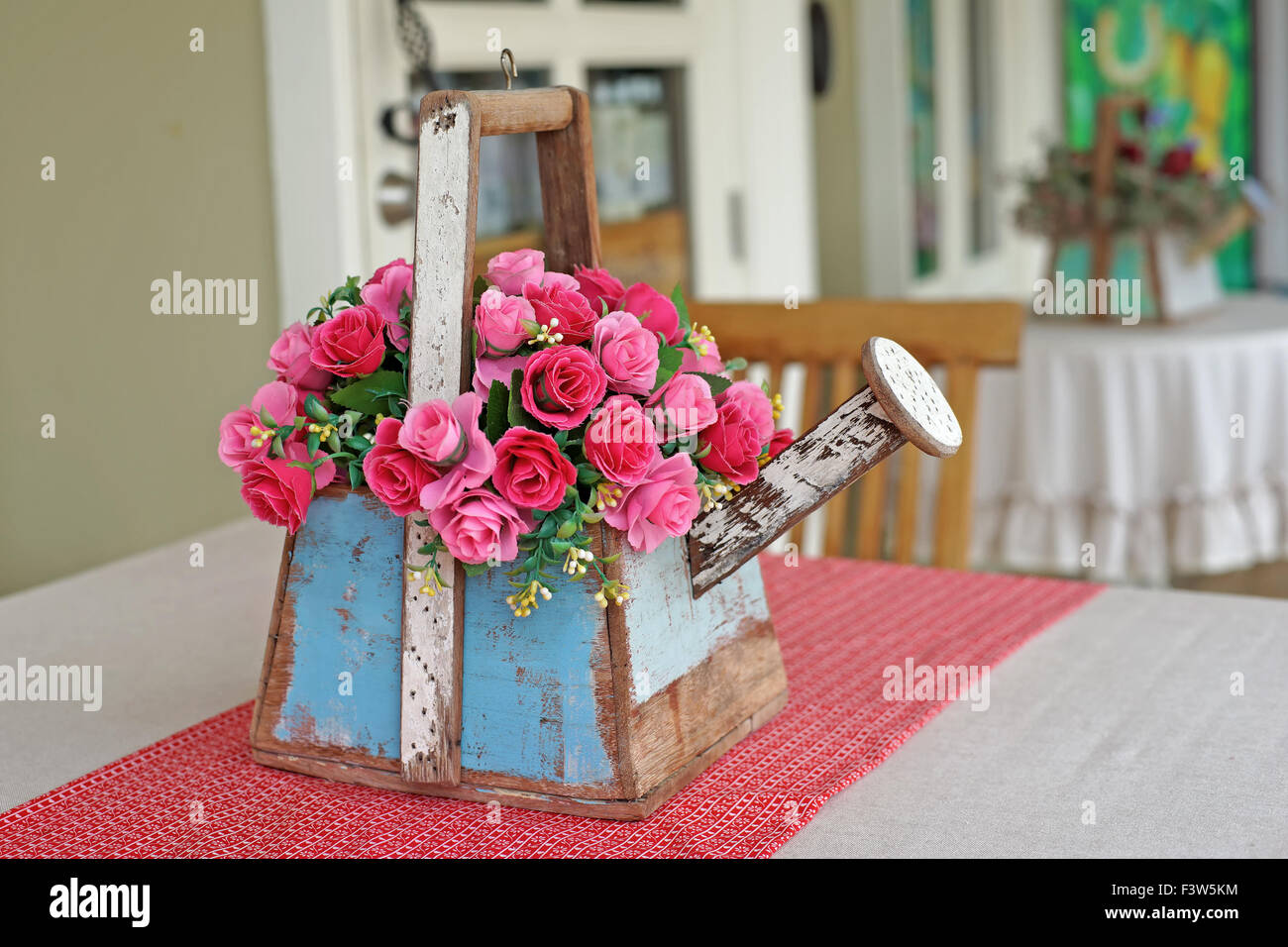 colorful rose artificial flower in wooden flowerpot Stock Photo