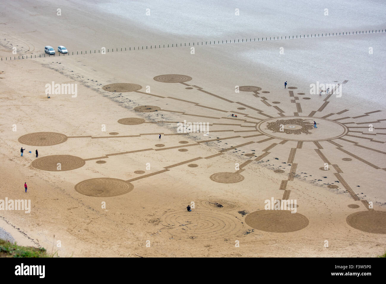 Elaborate sand circle artwork under construction on Brean Sands, Somerset, UK. Stock Photo