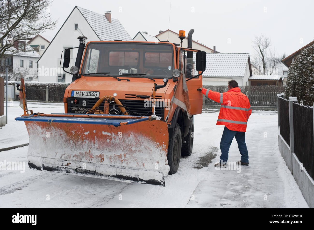 Snowplow with driver Stock Photo Alamy