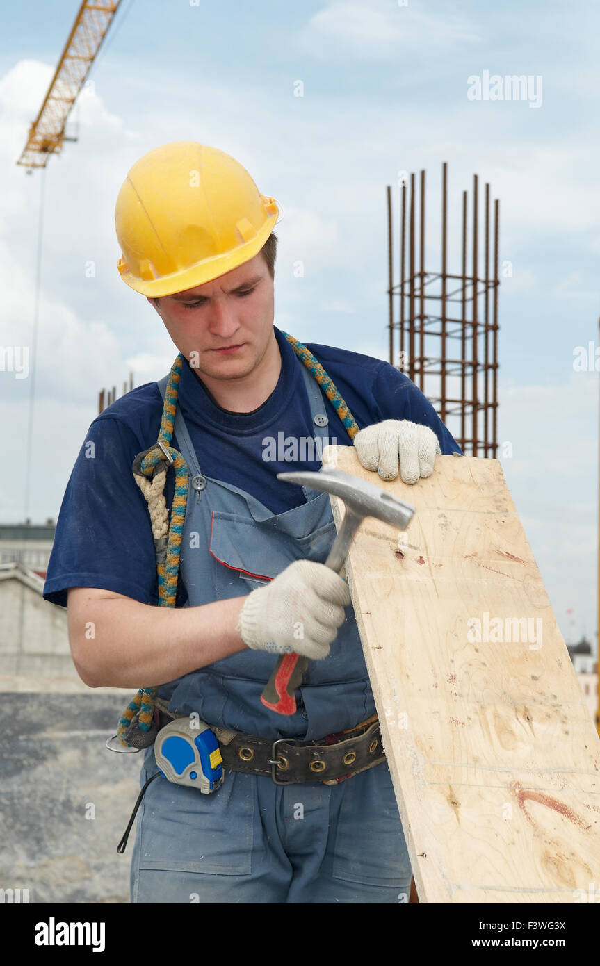 builder working with hammer and plywood Stock Photo