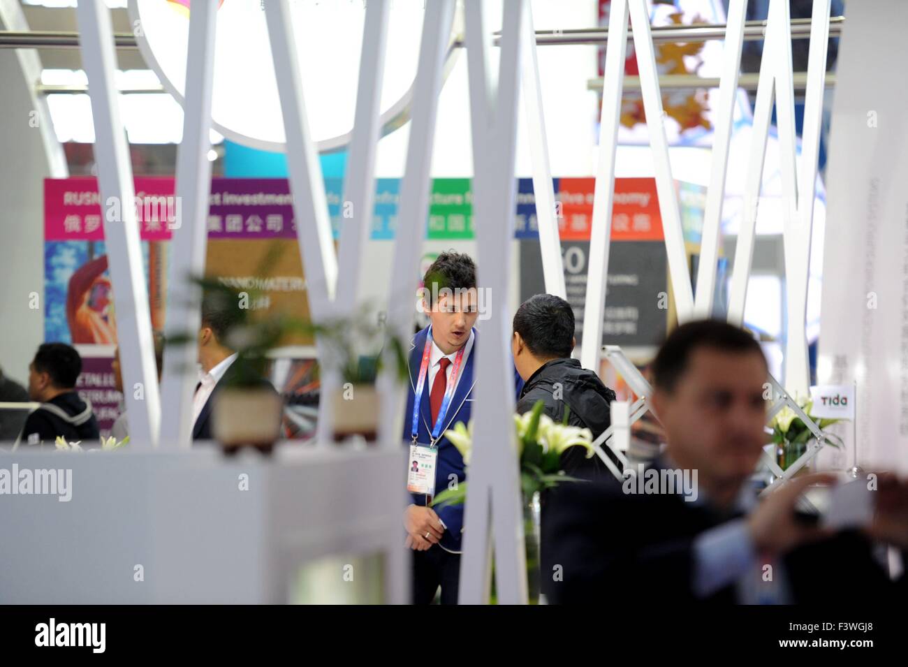 (151013) -- HARBIN, Oct. 13, 2015 (Xinhua) -- An exhibitor talks with an enterprise representative at the booth of Russian republic of Tatarstan during the second China-Russia Exposition in Harbin, northeast China's Heilongjiang Province, Oct. 13, 2015. Nearly 10,000 businessmen from 103 countries and regions attended the expo. The event will last till Oct. 16, 2015. (Xinhua/Wang Song)  (zhs) Stock Photo