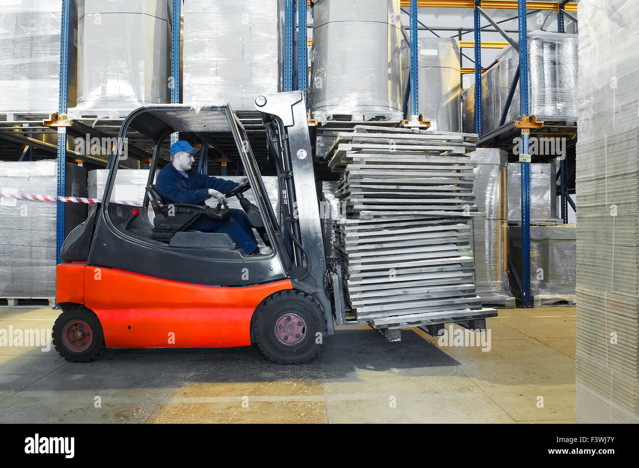 warehouse worker and forklift loader Stock Photo
