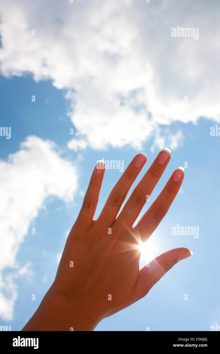 woman's hand against the sky Stock Photo