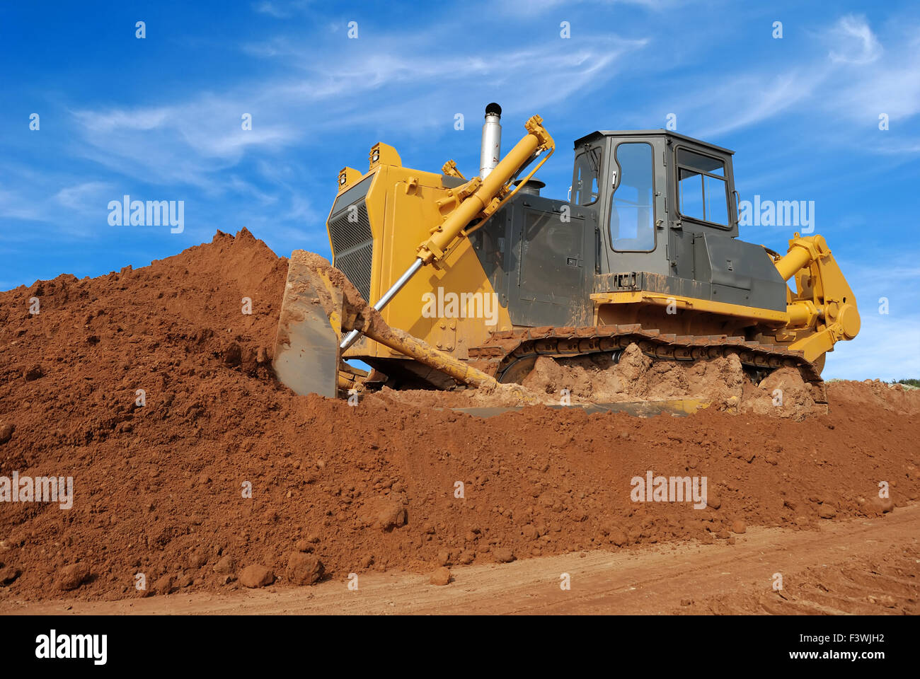 heavy bulldozer moving sand in sandpit Stock Photo