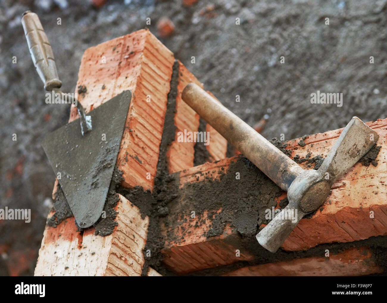 bricklayer equipment trowel and hack Stock Photo