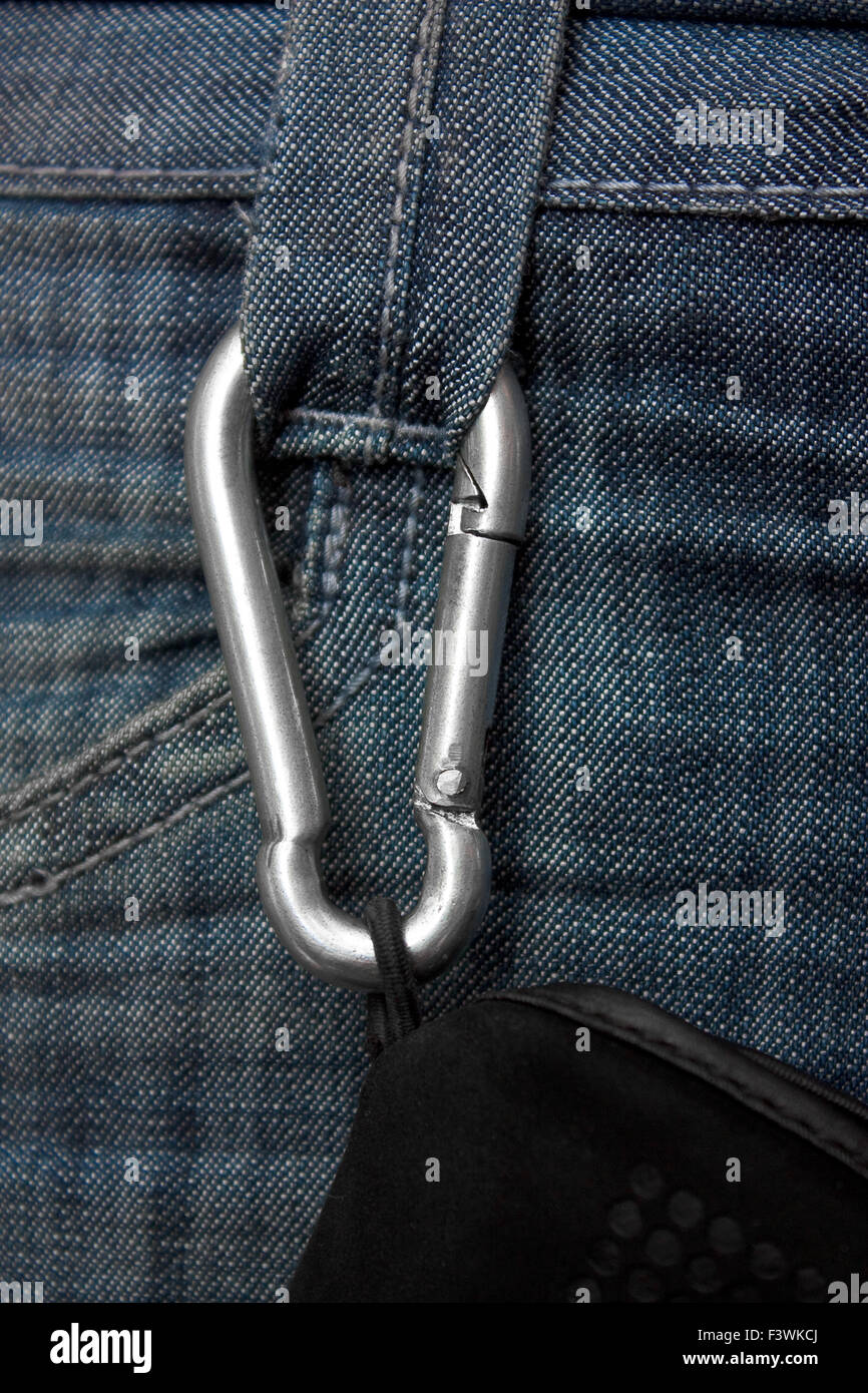 Carabiner with a rope fastened to the jeans Stock Photo