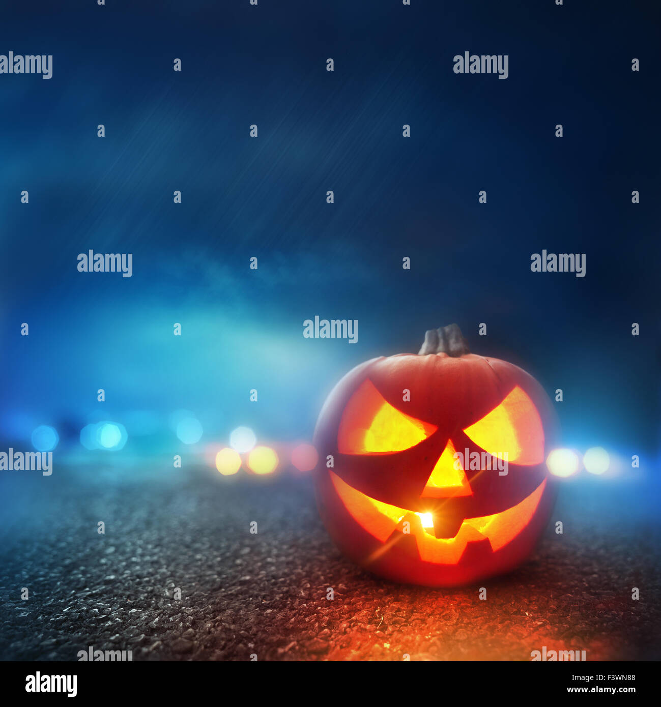 Halloween Evening. A Jack O Lantern Pumpkin glowing orange on Halloween evening. Stock Photo