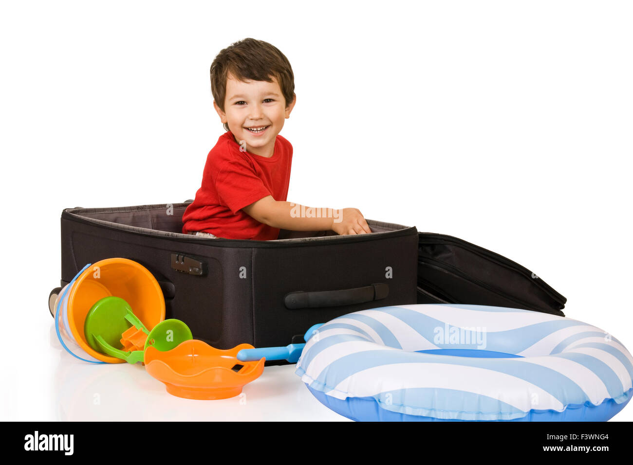 Little boy packs a suitcase Stock Photo
