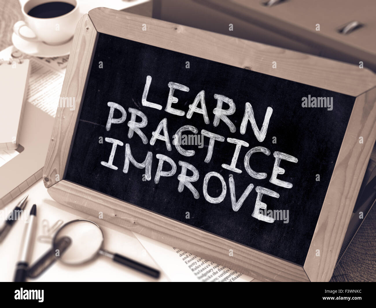 Learn, Practice, Improve. Handwritten by white Chalk on a Blackboard