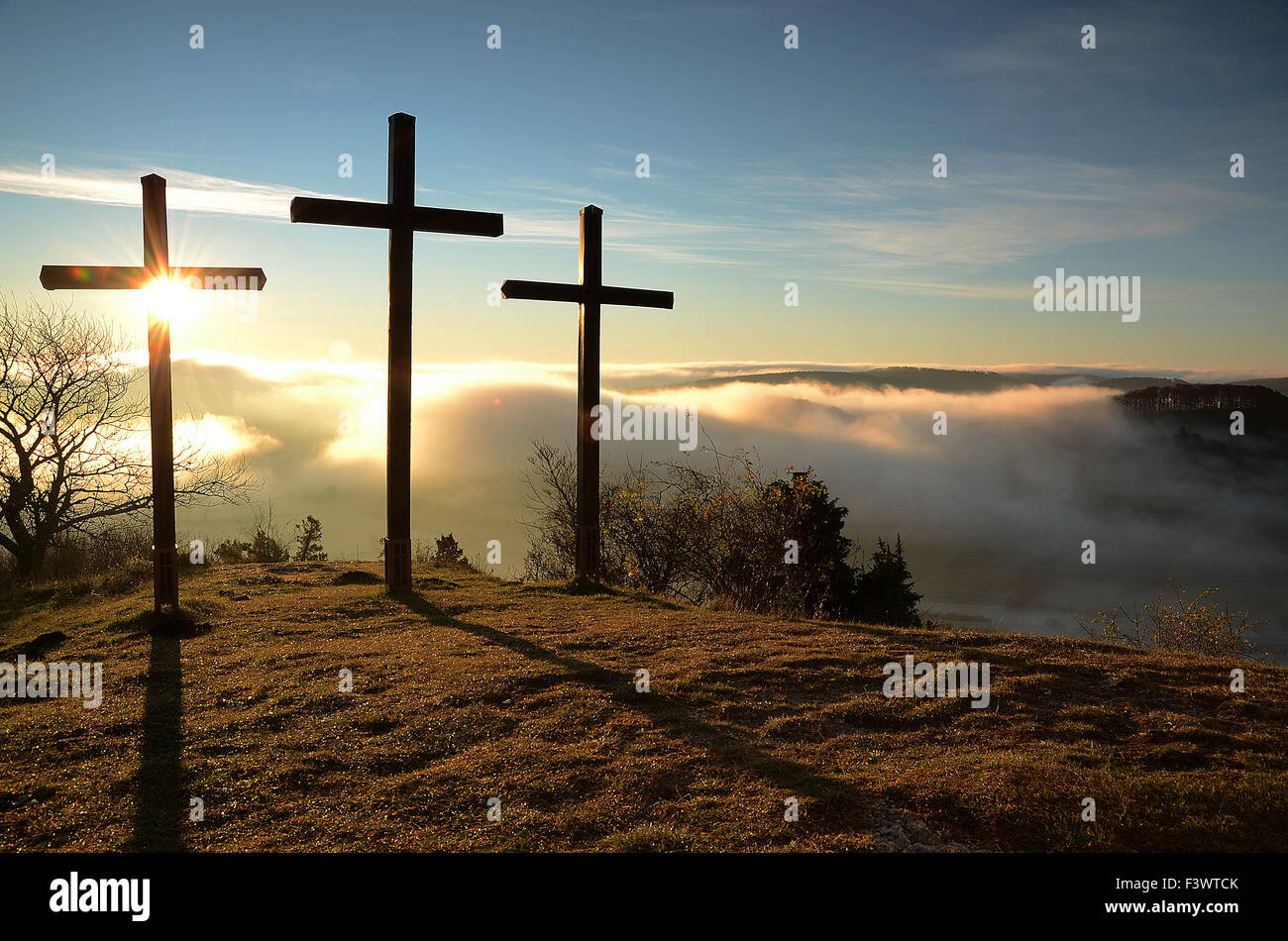 crosses at sunrise on Swabian Alb with fog Stock Photo