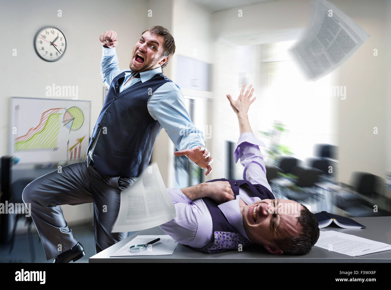 Two agressive businessmen fighting in the office Stock Photo