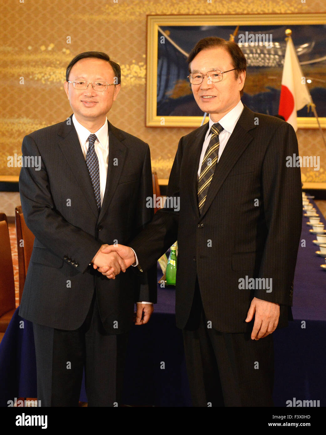 Tokyo, Japan. 13th Oct, 2015. Chinese State Councilor Yang Jiechi (L) shakes hands with Head of the Japanese national security council Yachi Shotaro in Tokyo, Japan, on Oct. 13, 2015. Credit:  Ma Ping/Xinhua/Alamy Live News Stock Photo