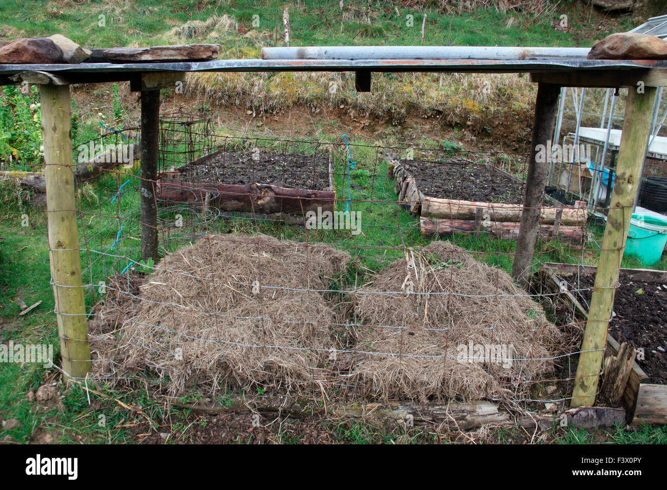 Compost container with mesh sides and waterproof tin roof Stock Photo