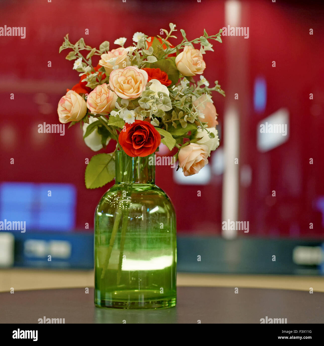colorful of rose artificial flower in green vase Stock Photo