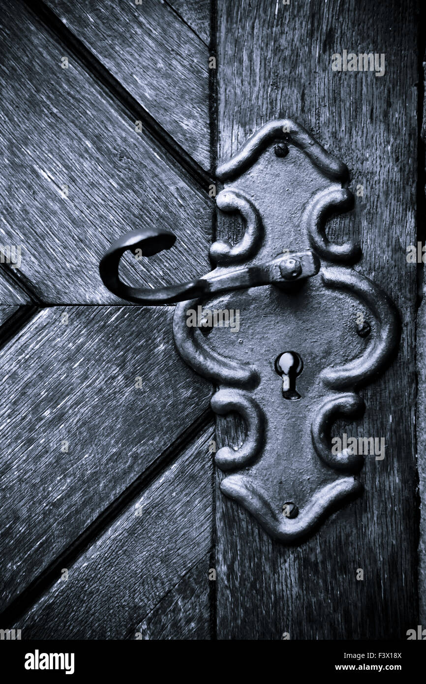 Retro keyhole in old wooden door Stock Photo