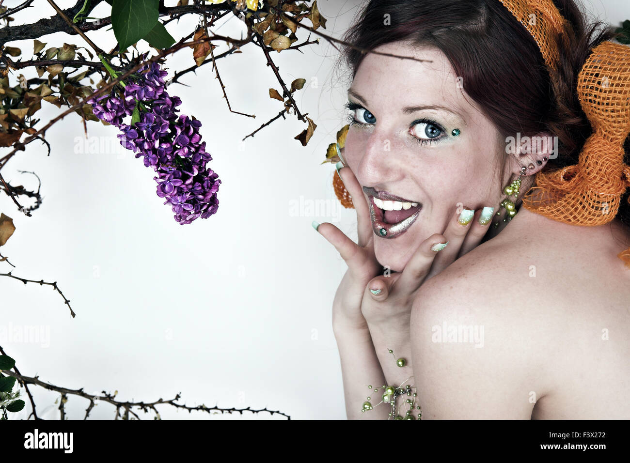 Shrill young woman with flowers Stock Photo