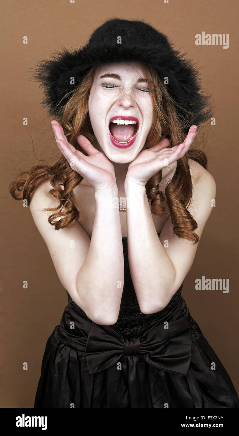 Woman screams in a brown background Stock Photo