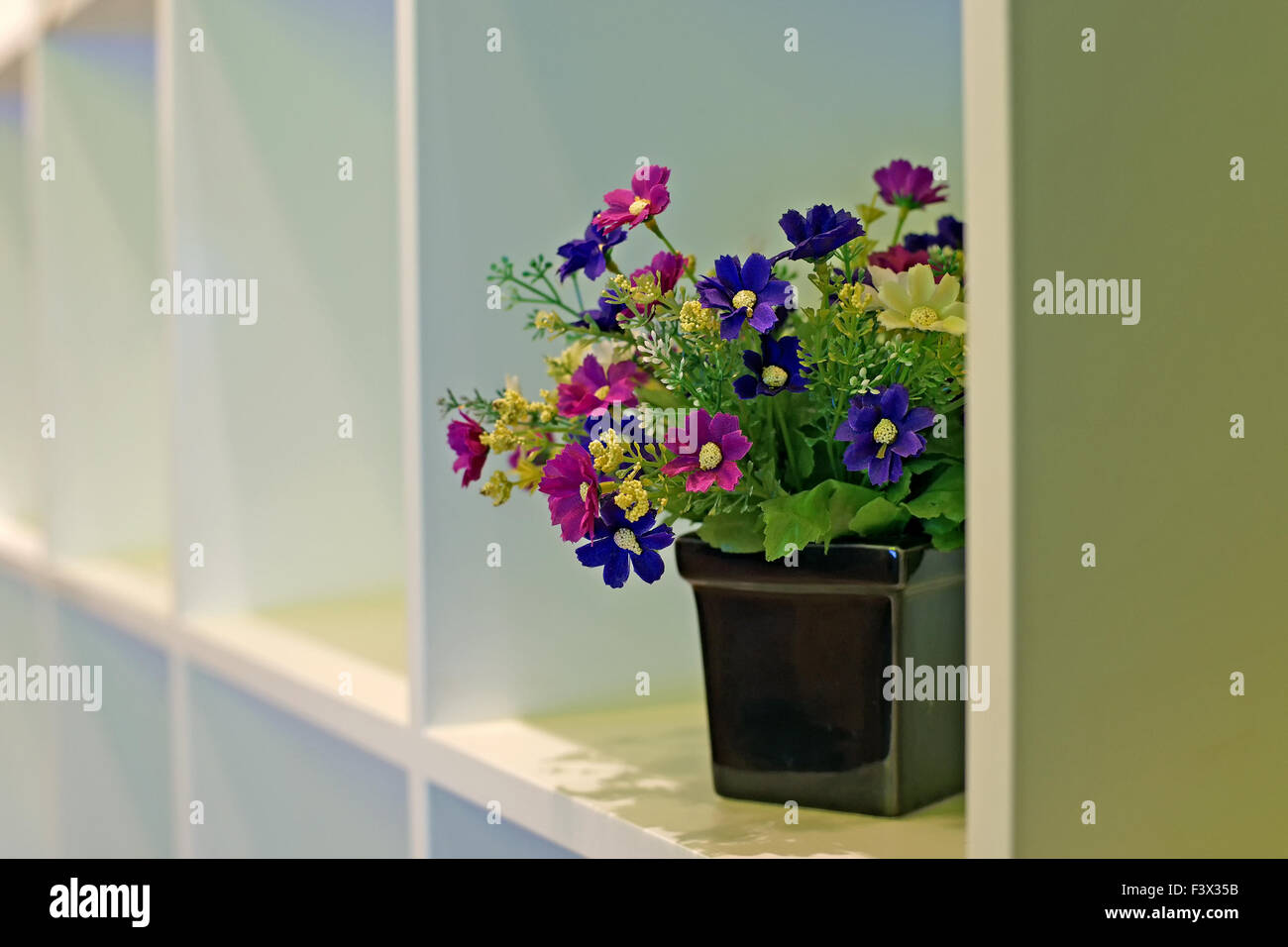 colorful artificial flower in flowerpot Stock Photo
