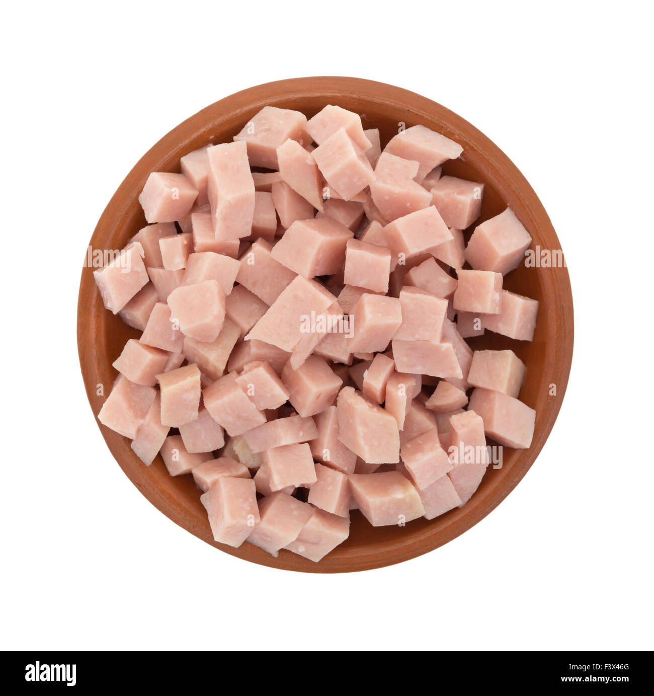 Top view of a portion of diced ham in a small clay bowl isolated on a