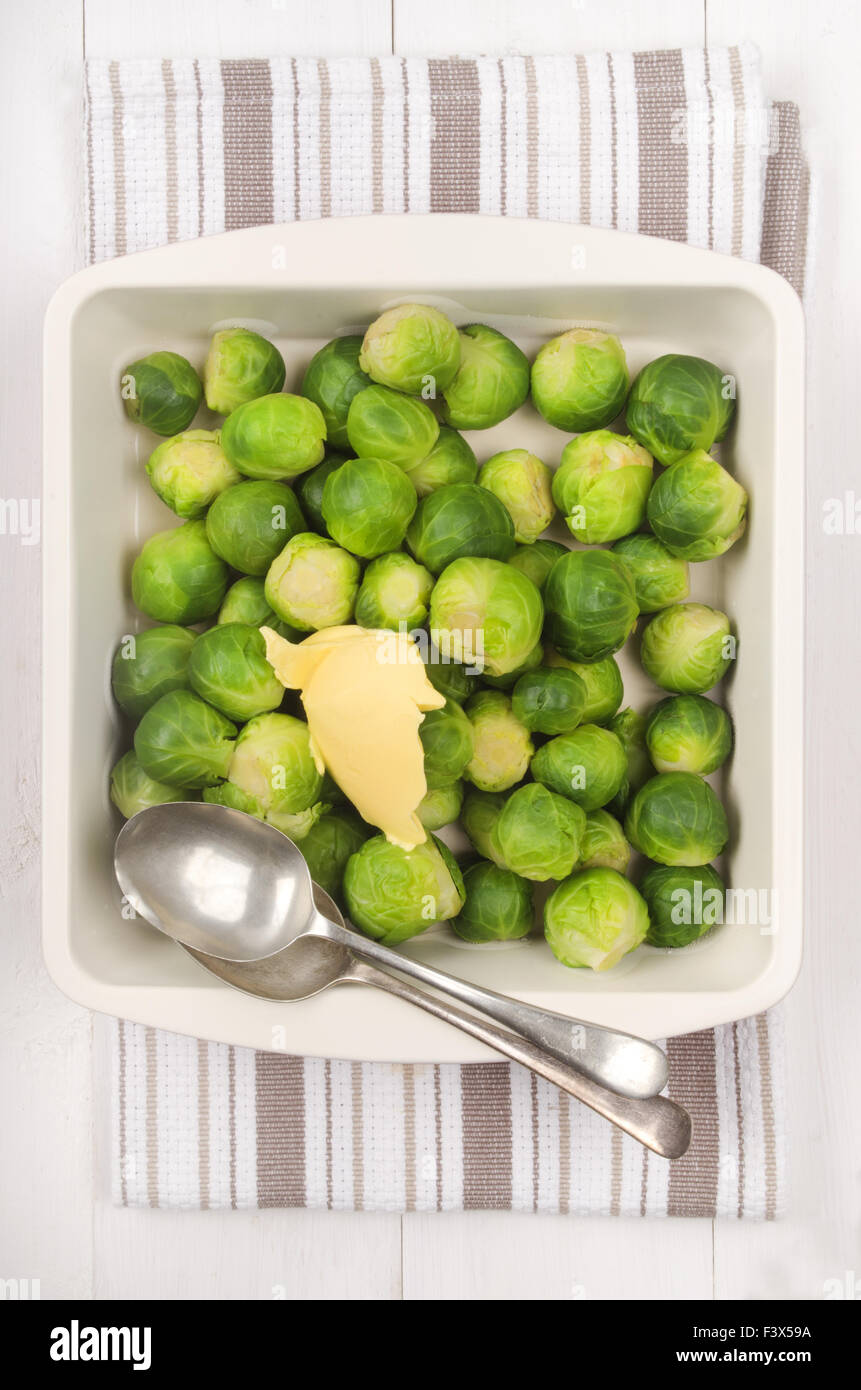 cooked brussels sprouts with butter in a bowl and spoon Stock Photo