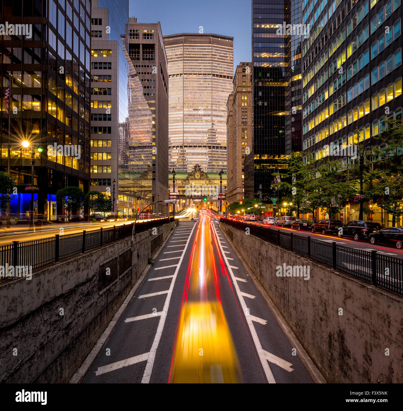 Car light trails in Park Avenue South, Midtown, Manhattan. Evening light on New York City skyscrapers and Grand Central Terminal Stock Photo