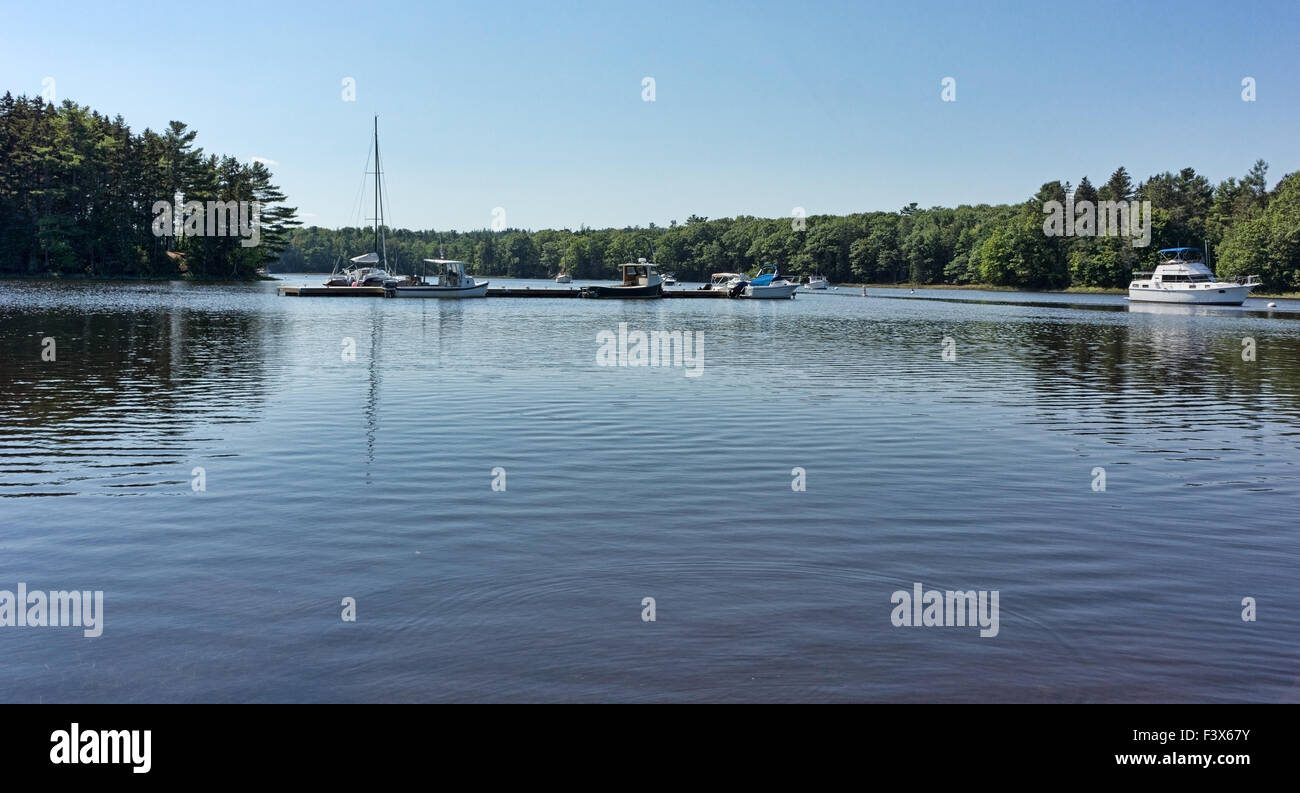 Boats moored and tied at dock on Union River at Ellsworth Maine in the