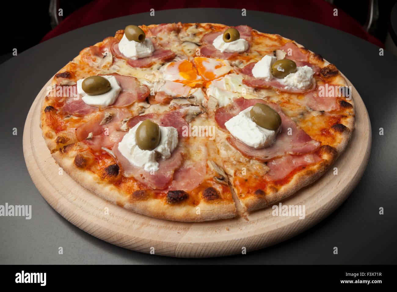 pizza with ham, sour cream, egg and green olives Stock Photo - Alamy