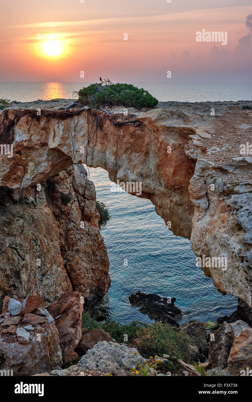Stone arch over coastline Stock Photo