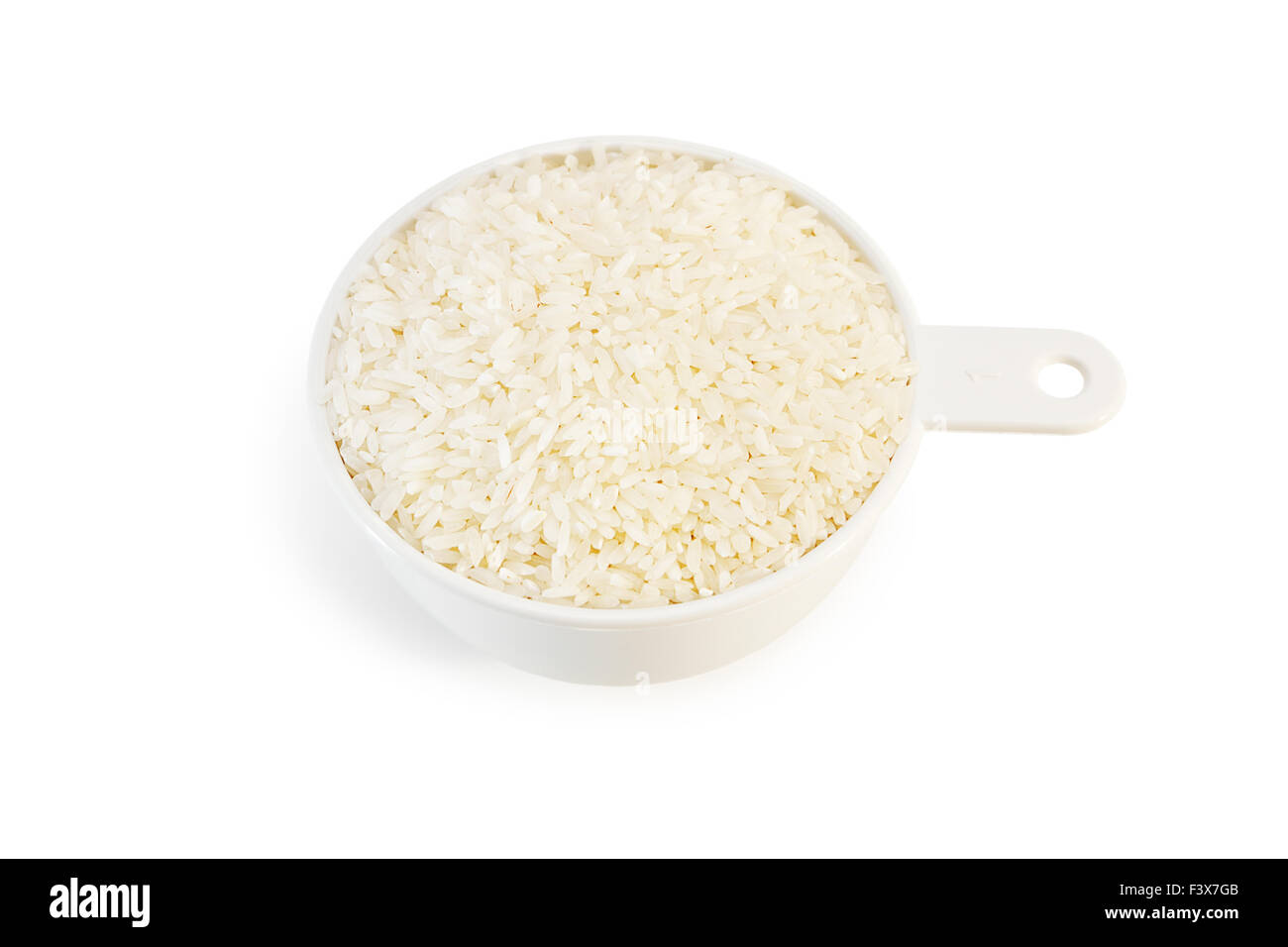 Measuring cup of rice on white Stock Photo Alamy