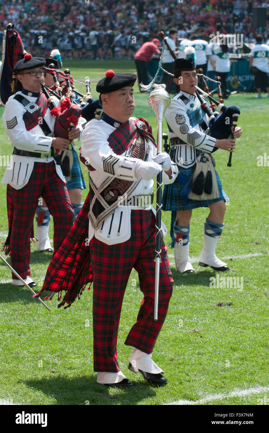Asian Drum Major leading bagpipers in a parade after a sevens rugby match in Hong Kong Stadium, China Stock Photo