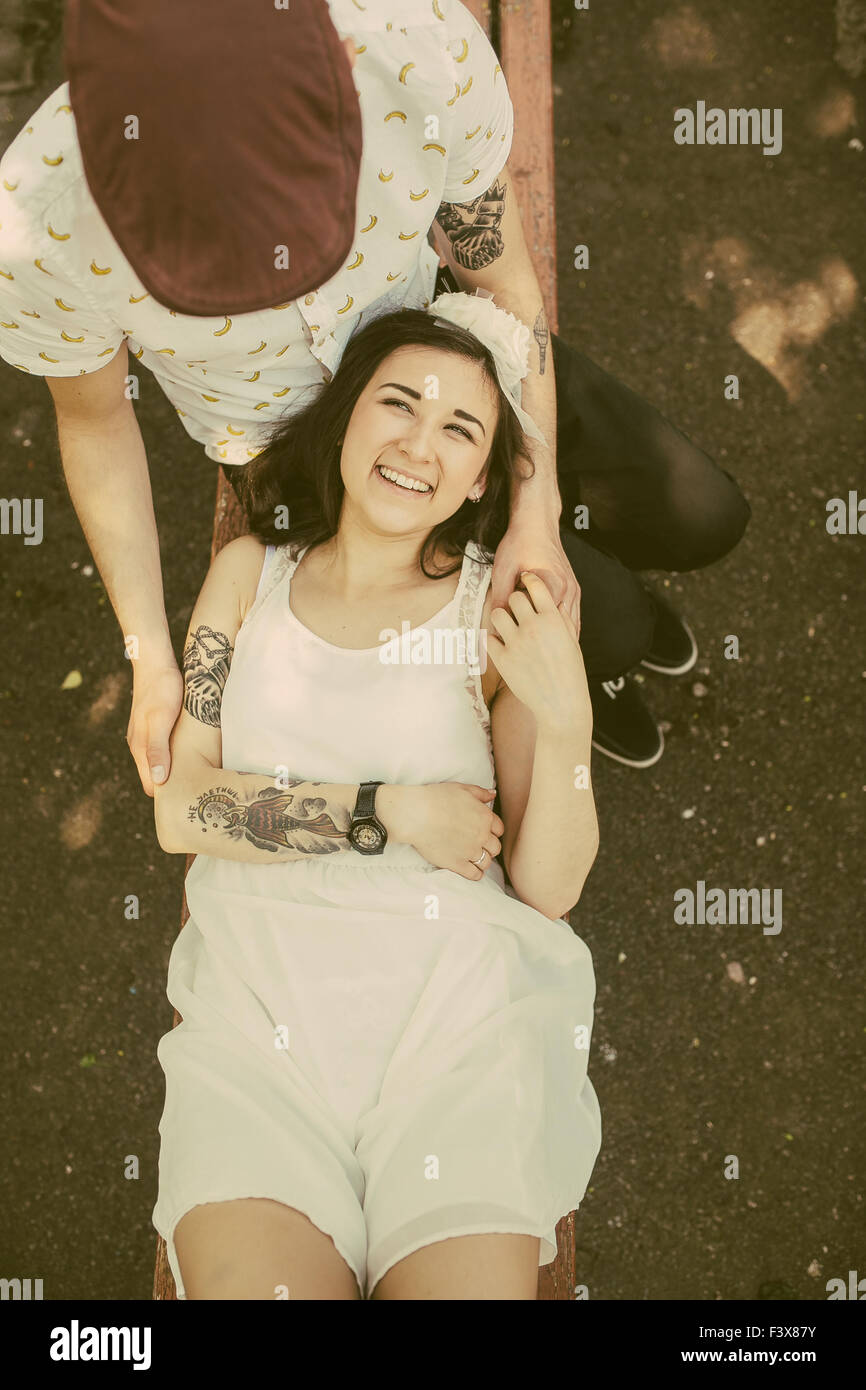 beautiful couple sits on a bench in the park and having fun Stock Photo ...