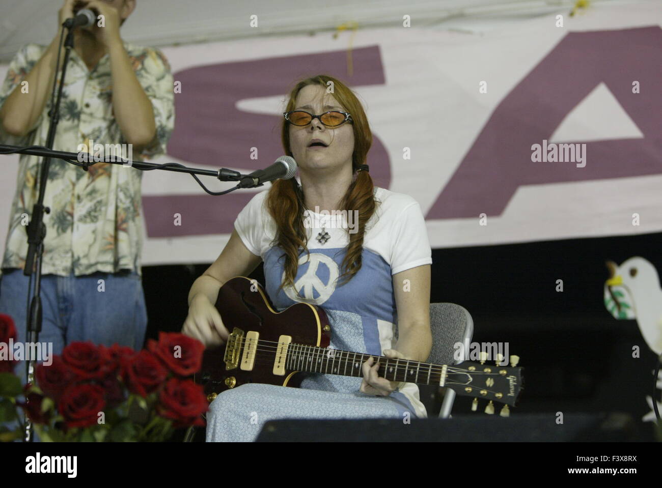 A peace activist sings anti-war songs during the protest against George W. Bush in Crawford, Texas. Stock Photo