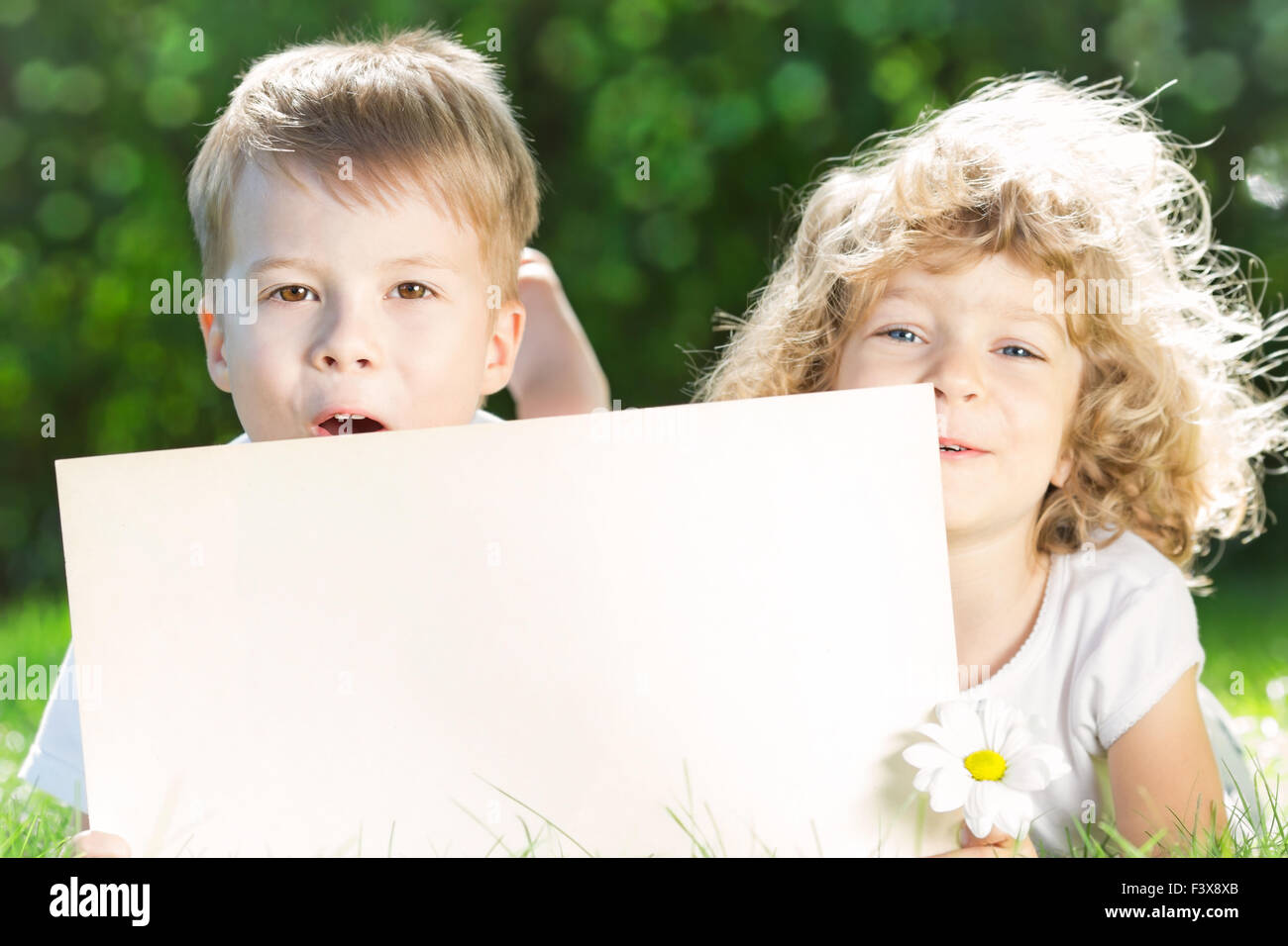 Children with paper blank Stock Photo - Alamy