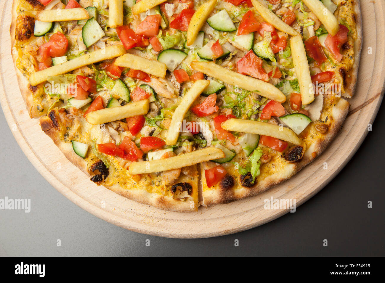 vegetarian pizza with cucumber, tomato and French fries Stock Photo