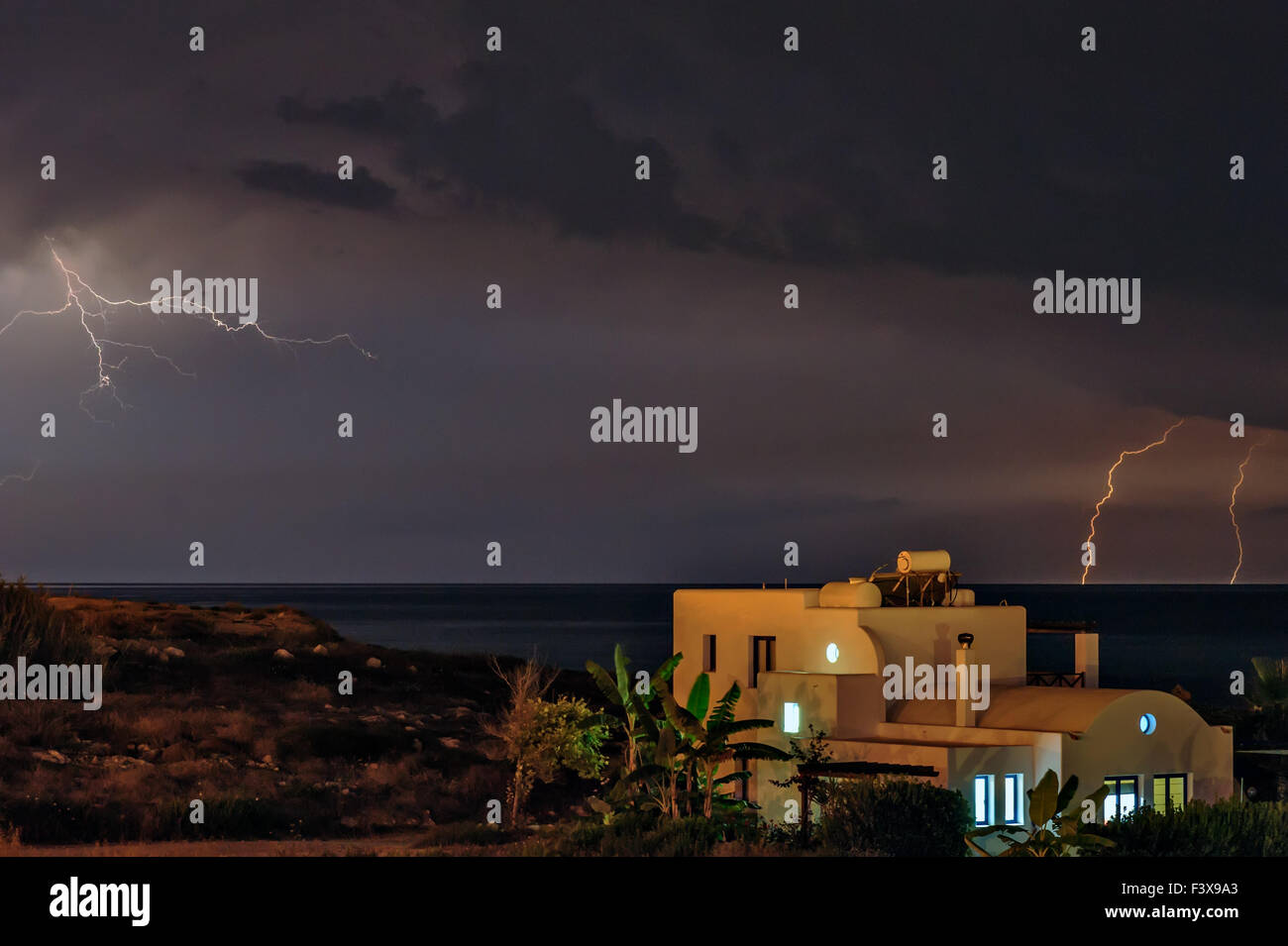 Lightning over beach house Stock Photo