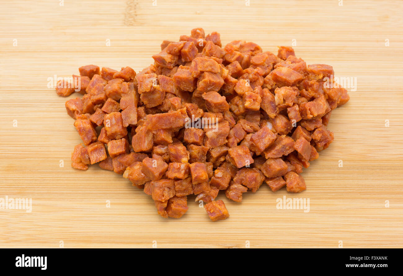 Pepperoni pizza topping that has been chopped into small cubes on a