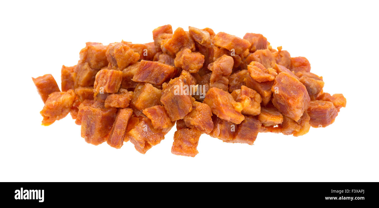 Pepperoni pizza topping that has been chopped into small cubes isolated