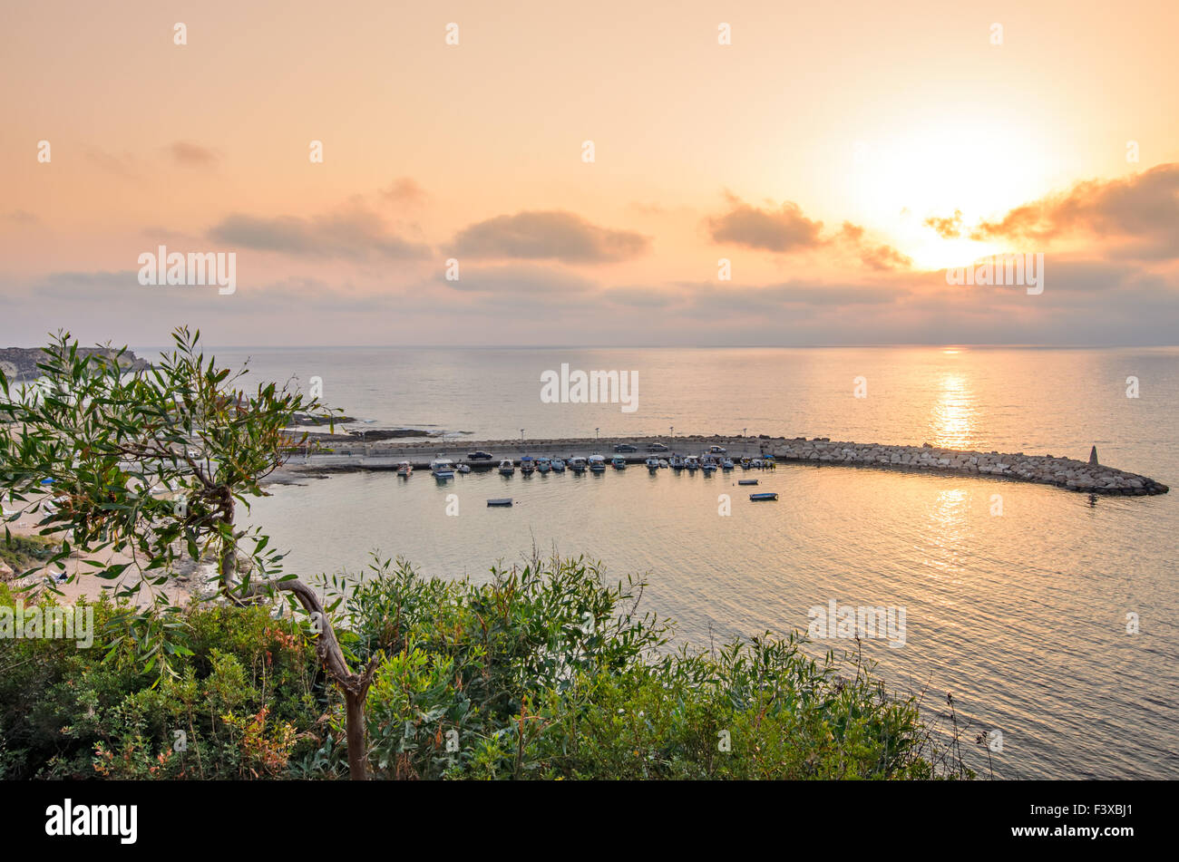 Sunset over bay for fishing boats Stock Photo
