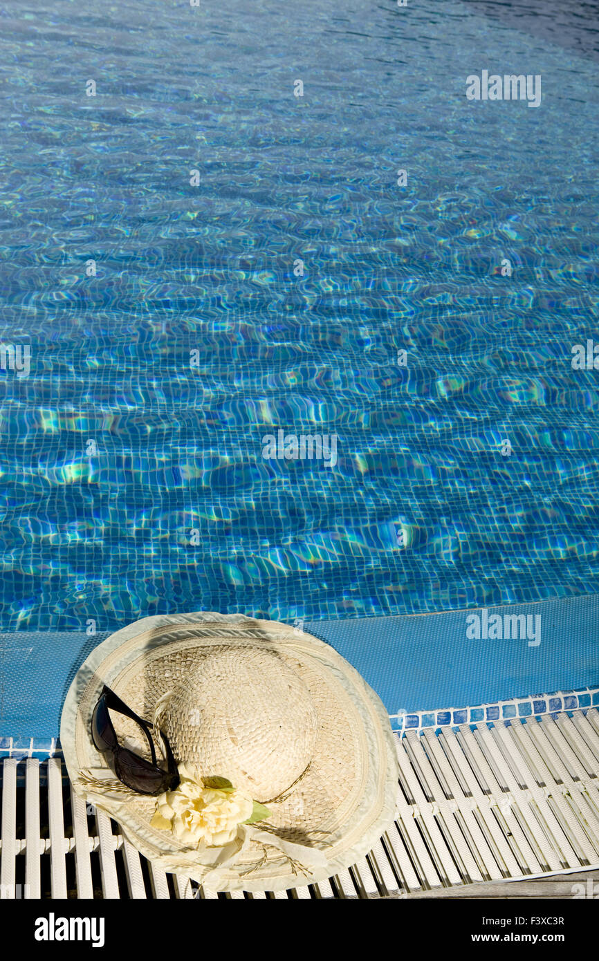 The straw hat lies on the brink of pool Stock Photo - Alamy