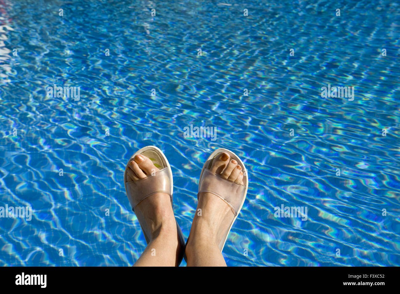 Feet in beach slippers Stock Photo - Alamy