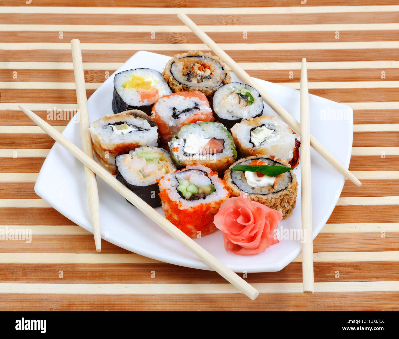 Sushi rolls on the plate with chopsticks Stock Photo