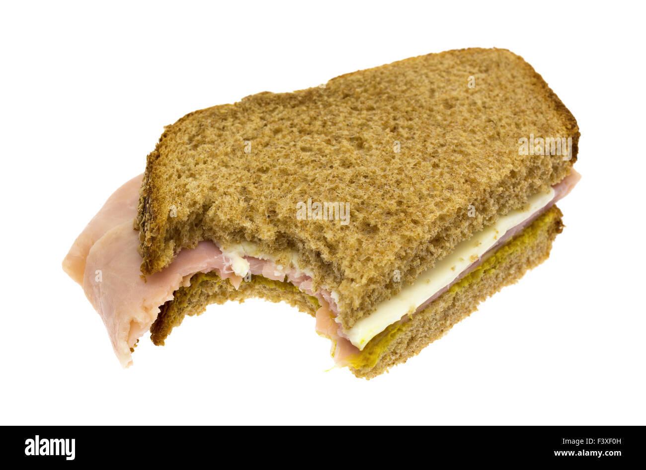 A ham and cheese sandwich that has been bitten once isolated on a white background. Stock Photo