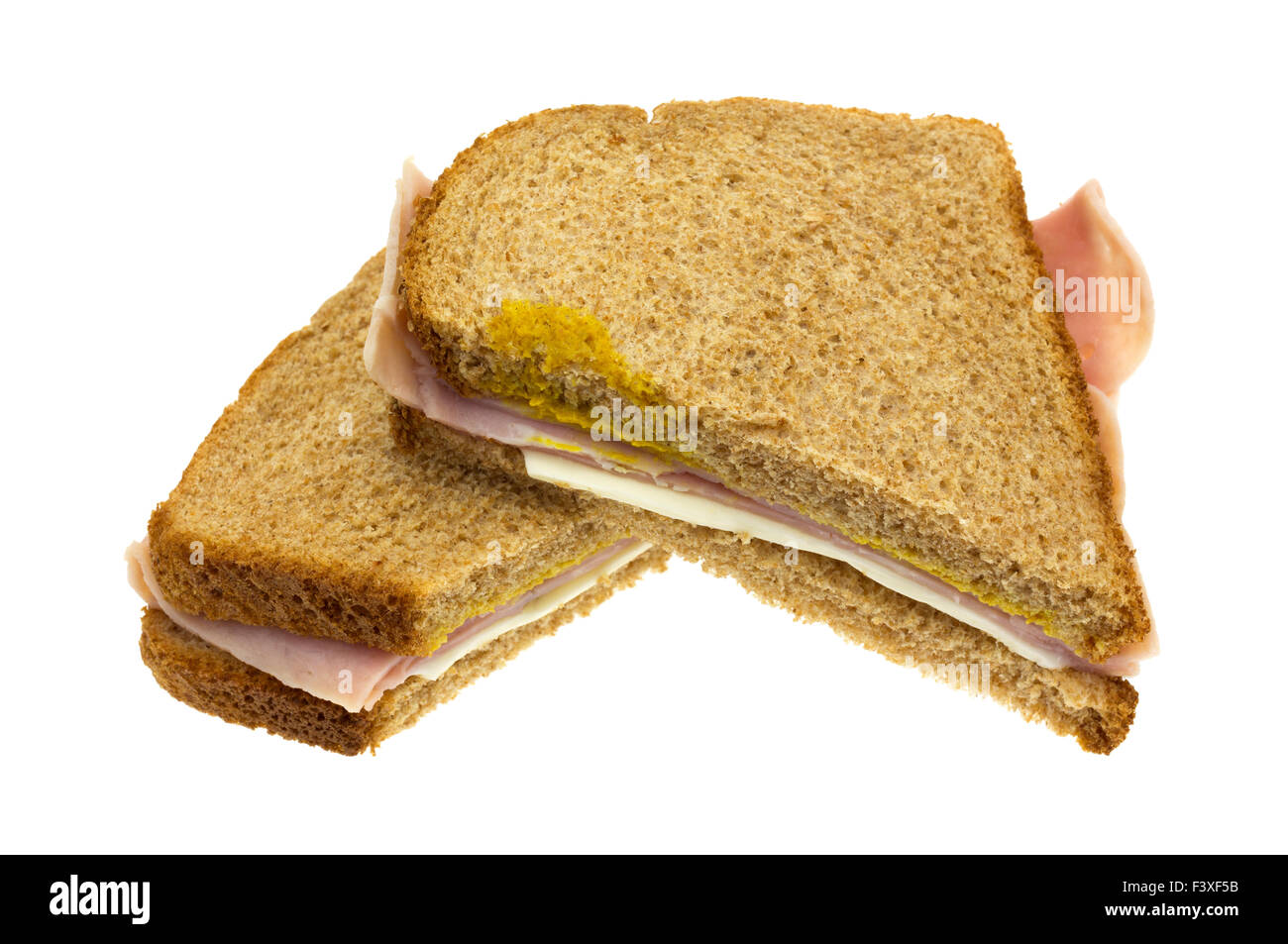 A ham and cheese sandwich that has been cut in half isolated on a white background. Stock Photo