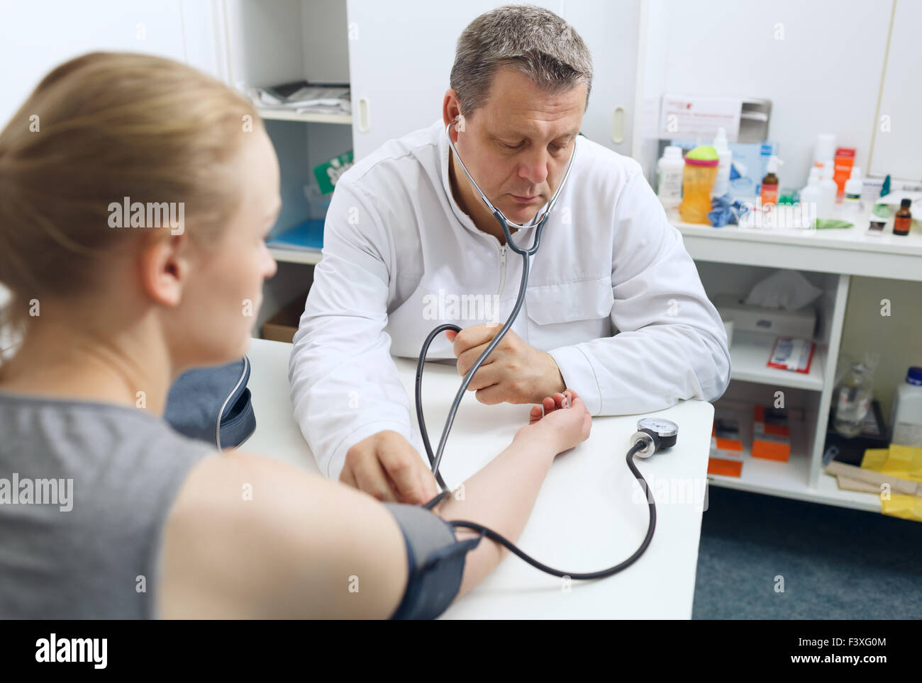 Blood pressure test doctor hi-res stock photography and images - Alamy