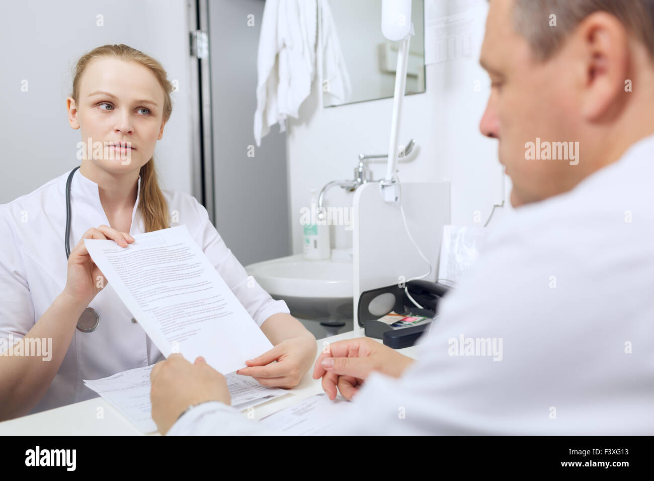 Nurse shows to doctor results of analyses Stock Photo