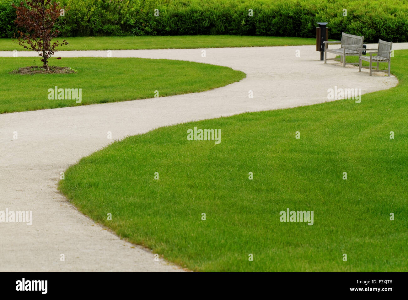 Winding path through a peaceful green garden Stock Photo