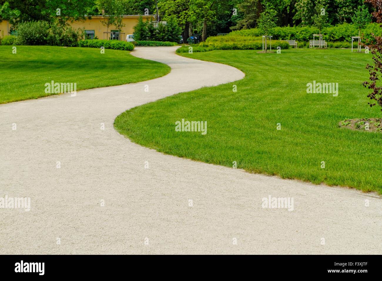 Winding path through a peaceful green garden Stock Photo